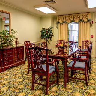 A cozy dining room with elegant furniture and decorative elements.