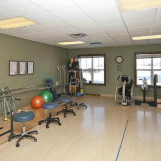 A well-equipped gym or exercise room with various fitness equipment and therapy balls.