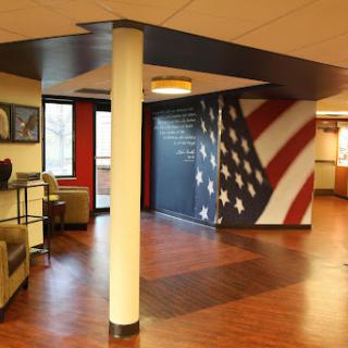 An inviting lobby space featuring an American flag mural and comfortable seating areas.