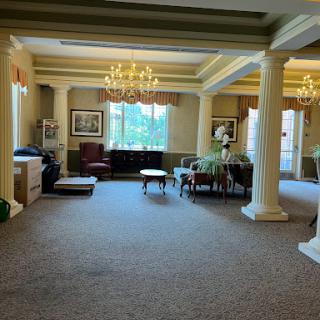 A spacious and elegantly designed lobby area featuring stylish furniture and decorative chandeliers.