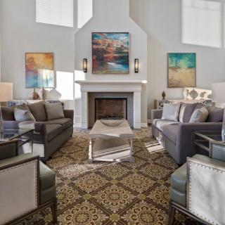A modern living room with elegant decor and a cozy fireplace.
