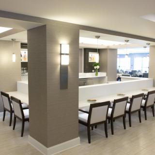 A modern dining area with neutral tones and sleek furniture.