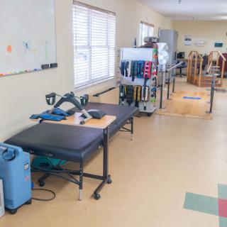 A view of a physical therapy room equipped with various rehabilitation tools and exercise equipment.