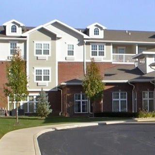 A modern apartment building with a mix of brick and siding exterior.