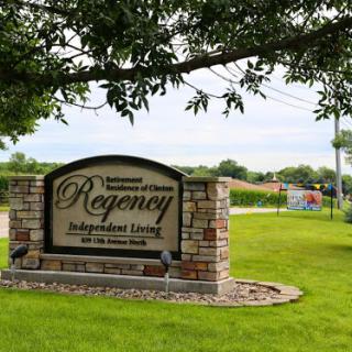 Welcome sign for Regency Independent Living situated on a lush green lawn.