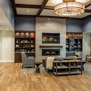 A modern living room with a fireplace, elegant seating, and stylish decor.