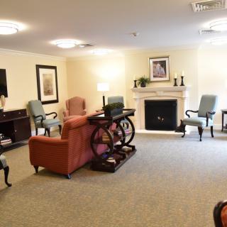 A cozy living room with a fireplace and comfortable seating arrangement.