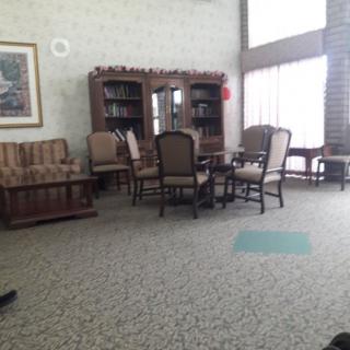 A cozy library interior with chairs and bookshelves.
