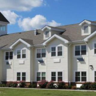 A modern residential apartment building under a blue sky.
