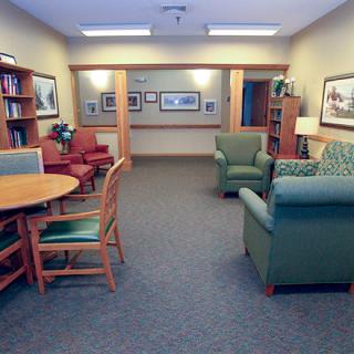 A cozy waiting room with comfortable seating and books on display.