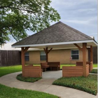 A charming gazebo surrounded by lush greenery, perfect for relaxation or gatherings.