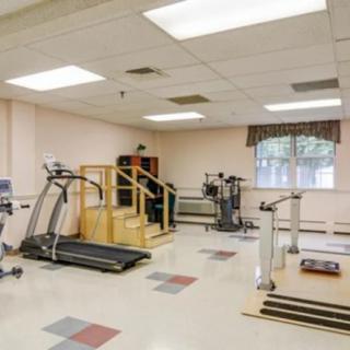 A rehabilitation gym equipped with treadmills and various exercise machines.