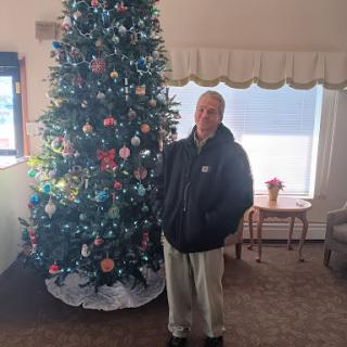A cheerful moment captured by the beautifully decorated Christmas tree.