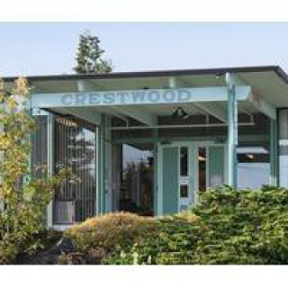The entrance of a building labeled 'Crestwood', featuring mid-century modern architectural design.