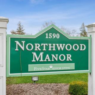 Entrance sign for Northwood Manor displaying the address 1590.