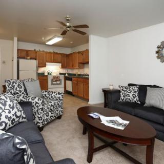 A cozy living and kitchen area featuring stylish furniture and a warm atmosphere.