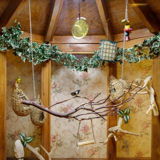 A cozy wooden interior adorned with a decorative branch and ivy garland.