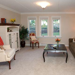A cozy living room with elegant furniture and large windows.
