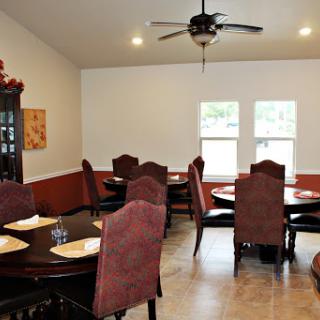 A cozy dining room featuring elegant furniture and ample natural light.