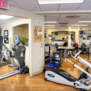 A fitness center with a variety of exercise equipment including treadmills and stationary bikes.