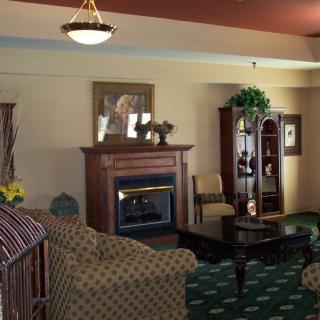 A cozy living room featuring a fireplace and classic furniture.