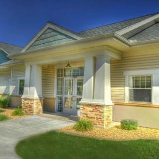 A modern residential building with a welcoming entrance and well-maintained landscaping.