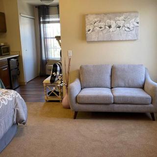 A modern living room with a gray sofa and stylish decor.