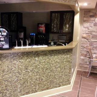 An indoor bar area with a counter and beverage dispensers.