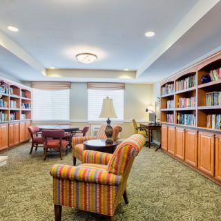 A cozy library with armchairs and bookshelves.