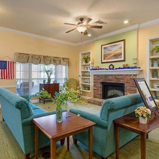 A cozy living room featuring a fireplace, comfortable sofas, and elegant decor.