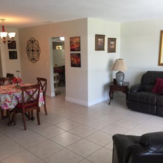 A cozy living and dining area with comfortable seating and a stylish dining setup.