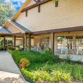 A well-maintained house with a landscaped garden and a cozy porch.