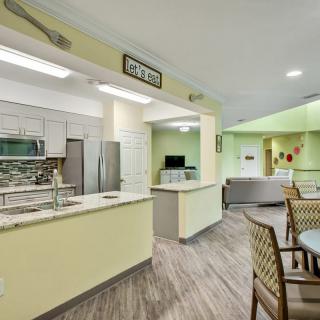 A modern kitchen and dining area with bright lighting and contemporary decor.