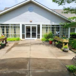 A welcoming building entrance adorned with plants and greenery.