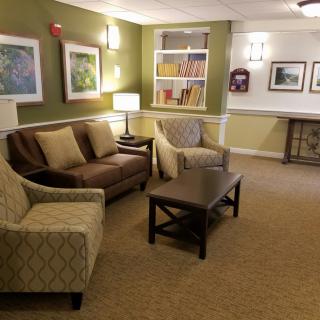 A cozy living room with a sofa, armchairs, and a coffee table.