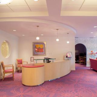 A modern office reception area with sleek furniture and bright lighting.