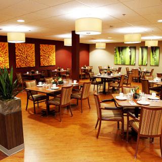 A modern restaurant interior featuring stylish furniture, ambient lighting, and decorative elements.
