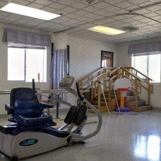 A rehabilitation room equipped with exercise machines and therapy equipment.