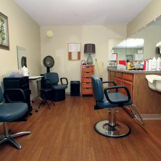 A well-equipped hair salon with multiple styling stations and chairs.