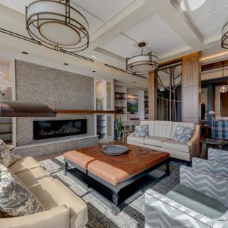 A contemporary living room featuring modern furniture and a sleek fireplace.
