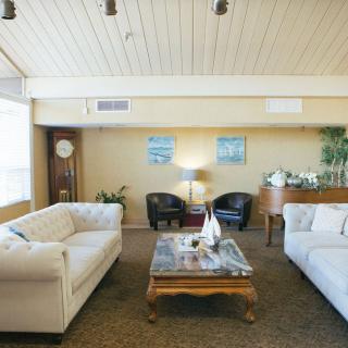 A cozy living room with white sofas, a wooden coffee table, and modern decor.