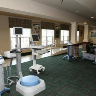 A treatment room equipped with various medical devices and monitors.