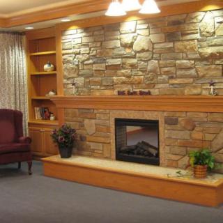 A cozy living room with a brick wall fireplace and comfortable seating.