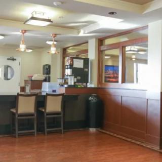 A quiet reception area with a desk and chairs.