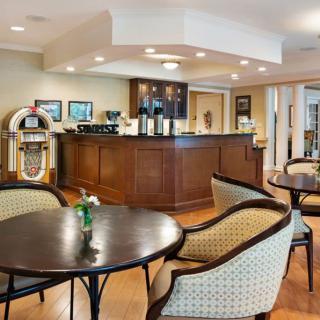 A cozy cafe interior with comfortable seating and a jukebox.