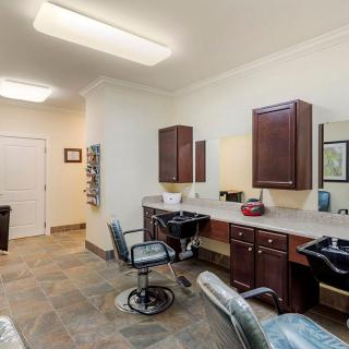 Modern hair salon interior with chairs, mirrors, and wooden cabinets.