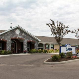 Exterior view of a nursing home with a welcoming entrance and well-maintained landscaping.