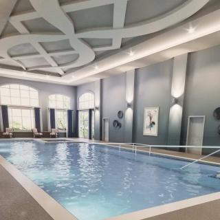 A luxurious indoor swimming pool with modern architectural design.