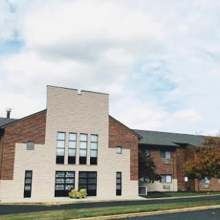 A modern residential building under a cloudy sky.
