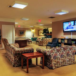 A cozy lounge with comfortable seating and a television.
